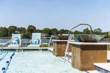 A pool with blue lane markers and a diving board.